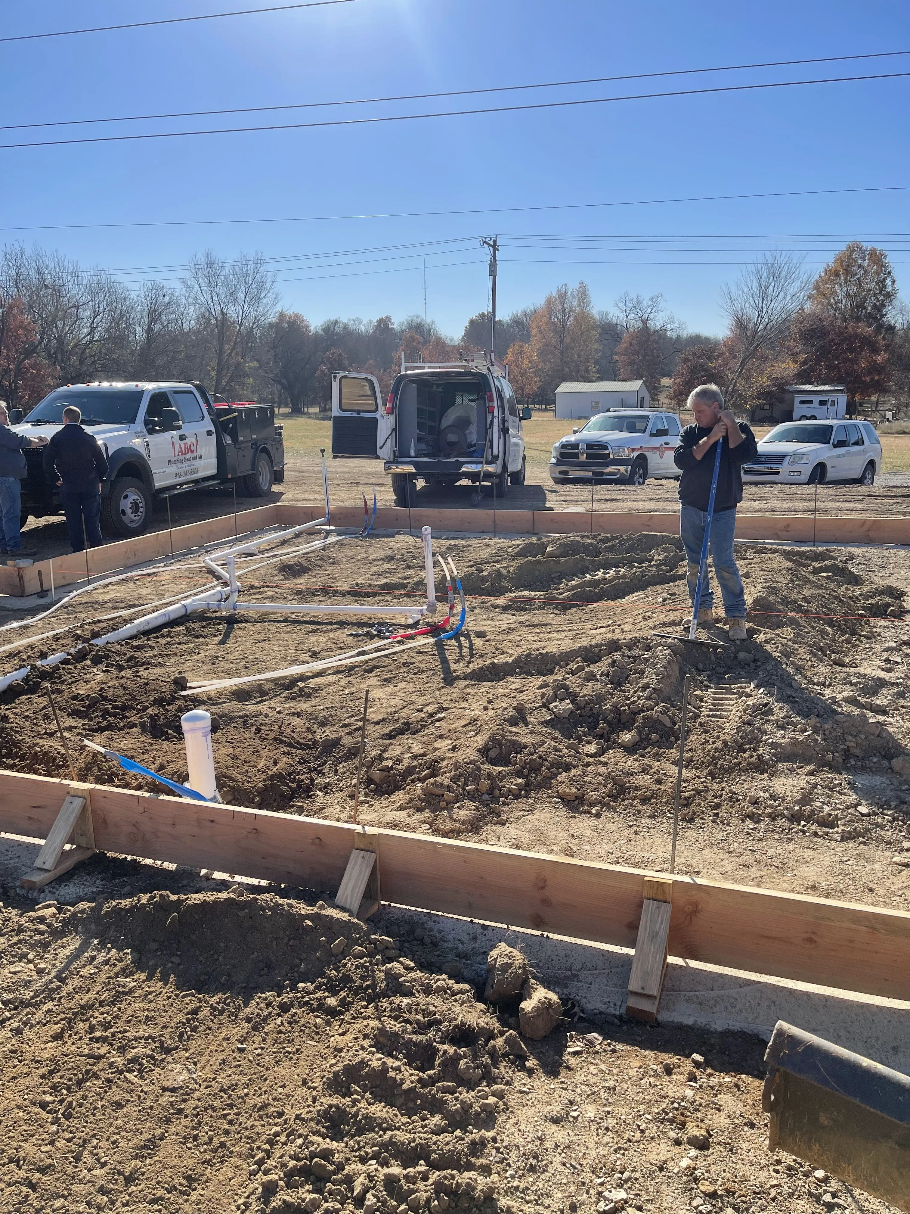 Brian and the crew on a foundation job site with the ABC truck parked behind them